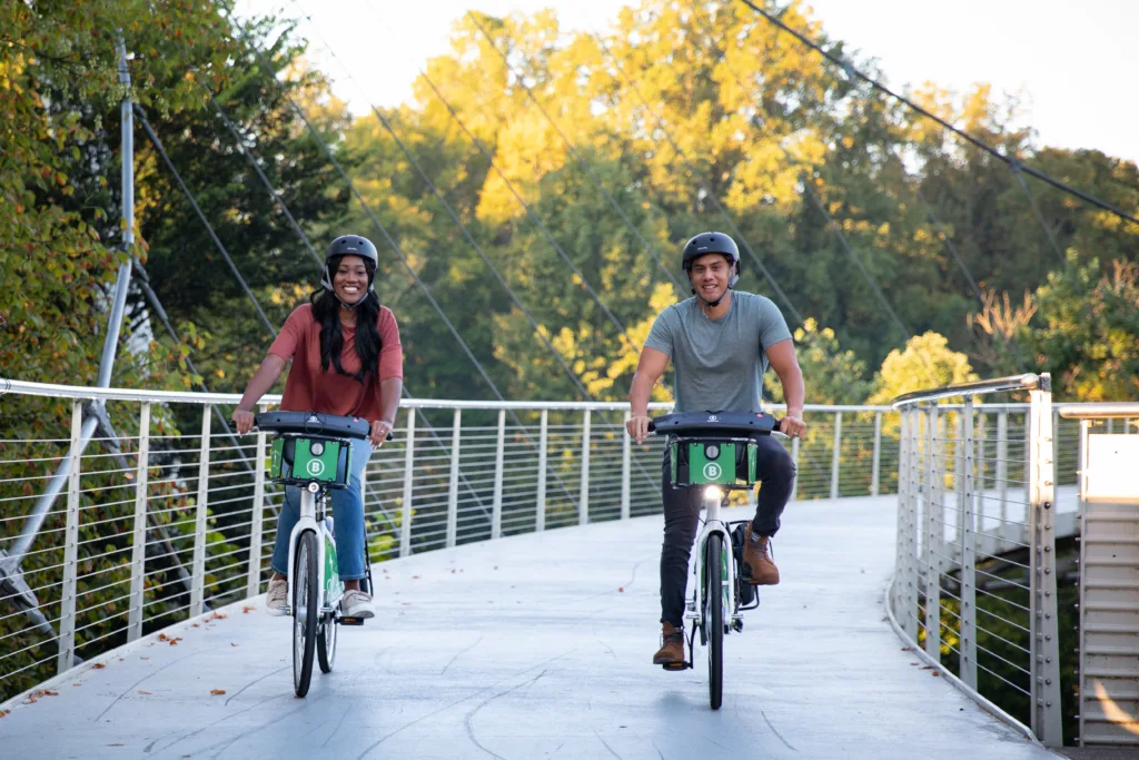 Woman and man riding bike share bicycles in Greenville